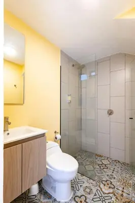 a bathroom with a toilet and a sink and a shower at L1 7BR Laureles House rooftop jacuzzi AC in Medellín