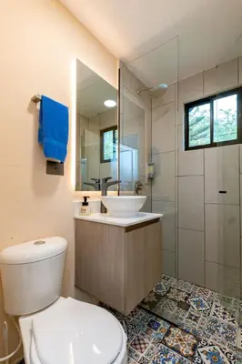 a bathroom with a toilet and a sink and a shower at L3 9BR Laureles House Rooftop 2 Jacuzzis AC in Medellín