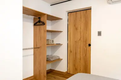 a room with a wooden door and shelves at L3 9BR Laureles House Rooftop 2 Jacuzzis AC in Medellín