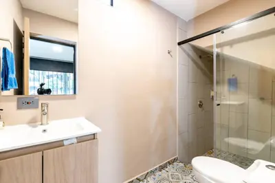 a bathroom with a sink and a toilet and a shower at L3 9BR Laureles House Rooftop 2 Jacuzzis AC in Medellín