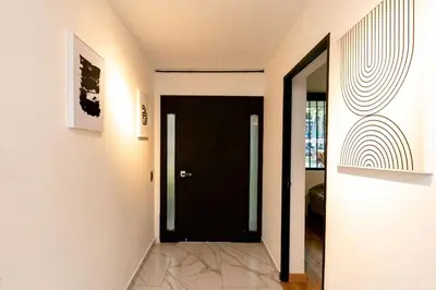 a hallway with a black door in a house at L3 9BR Laureles House Rooftop 2 Jacuzzis AC in Medellín