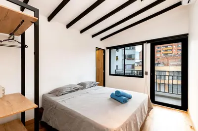 a bedroom with a bed with a blue towel on it at L3 9BR Laureles House Rooftop 2 Jacuzzis AC in Medellín