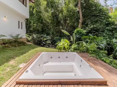 a bathtub in the backyard of a house at CH65 Luxury 5BR Villa Jacuzzi Garden de Oro in Medellín