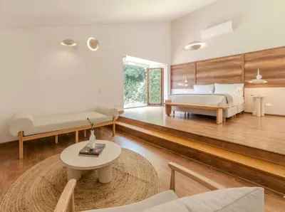 a bedroom with a bed and a couch and a table at CH65 Luxury 5BR Villa Jacuzzi Garden de Oro in Medellín