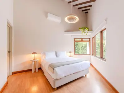 a white bedroom with a bed and a window at CH65 Luxury 5BR Villa Jacuzzi Garden de Oro in Medellín