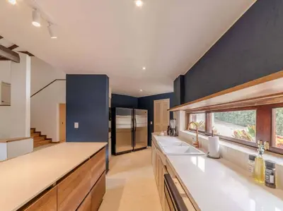 a kitchen with blue walls and white counter tops at CH65 Luxury 5BR Villa Jacuzzi Garden de Oro in Medellín