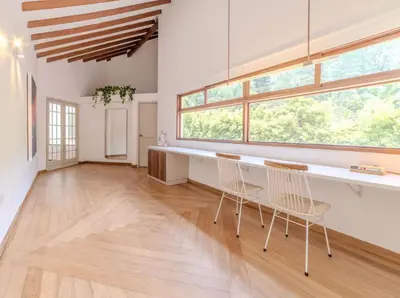 a room with two chairs and a table and windows at CH65 Luxury 5BR Villa Jacuzzi Garden de Oro in Medellín
