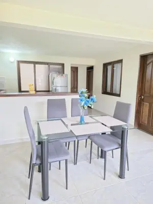 a table and chairs with a vase of flowers on it at Casa completa Comodidad-Ubicación Perfecta-CarmenV in Carmen de Viboral