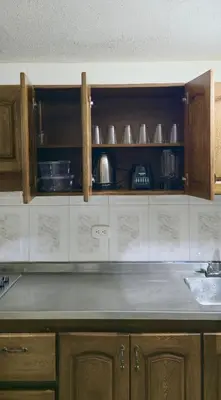 a kitchen with wooden cabinets and a counter top at Casa completa Comodidad-Ubicación Perfecta-CarmenV in Carmen de Viboral
