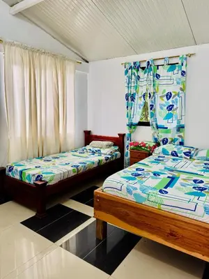 a bedroom with two beds and a window at Cabaña Verdeazul in San Rafael