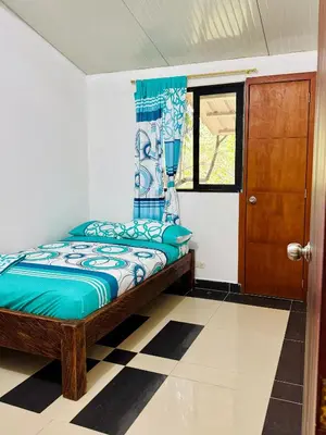 a bedroom with a bed and a window and a door at Cabaña Verdeazul in San Rafael