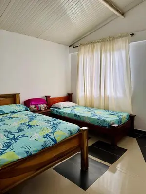 a bedroom with two beds and a window at Cabaña Verdeazul in San Rafael