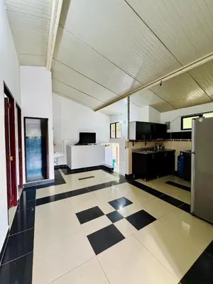 a large kitchen with a checkered floor in a building at Cabaña Verdeazul in San Rafael