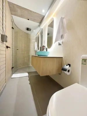 a bathroom with a sink and a toilet at Hotel Once22 in Sabaneta