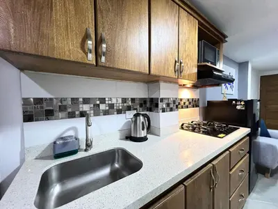 a kitchen with a sink and a stove at Apartamento Florelba-a solo dos cuadras del parque in Carmen de Viboral