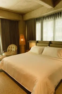 a bedroom with a large white bed and a chair at 23 Living in Medellín