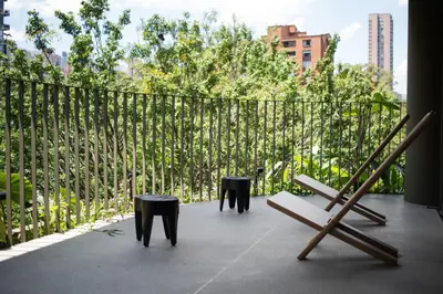 a balcony with two benches and a fence at 23 Living in Medellín