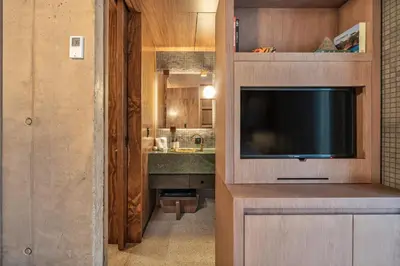 a living room with a television and a sink at 23 Living in Medellín