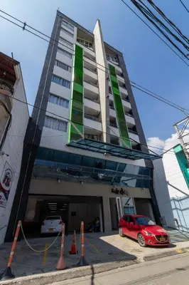 a red car parked in front of a building at Apartasuite Stay & Relax Itagui in Itagüí