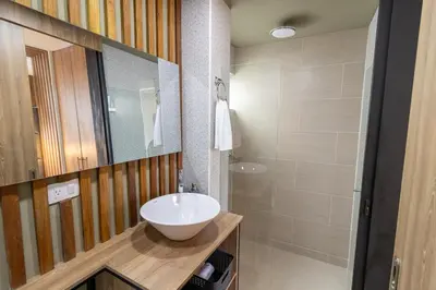 a bathroom with a white sink and a shower at Apartasuite Stay & Relax Itagui in Itagüí