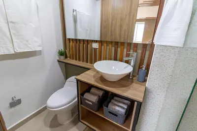 a bathroom with a white toilet and a sink at Apartasuite Stay & Relax Itagui in Itagüí