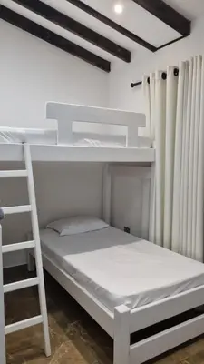 a bedroom with two bunk beds and a ladder at Balcones Guatape Apartment in Guatapé