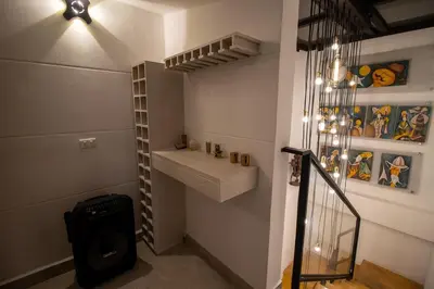 a hallway with a staircase with a sink and a shelf at Penthouse Stay & Relax Itagui in Itagüí