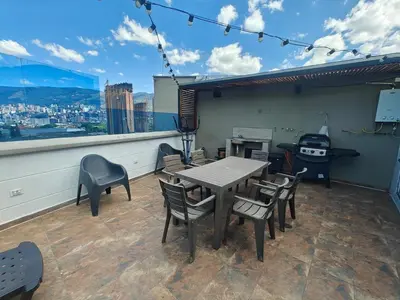a patio with a table and chairs on a balcony at Penthouse Stay & Relax Itagui in Itagüí