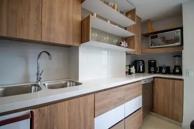 a kitchen with wooden cabinets and a sink at Penthouse Stay & Relax Itagui in Itagüí