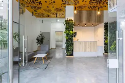 an office lobby with a yellow ceiling at Edificio Aiana Verde by Host Medellin in Medellín