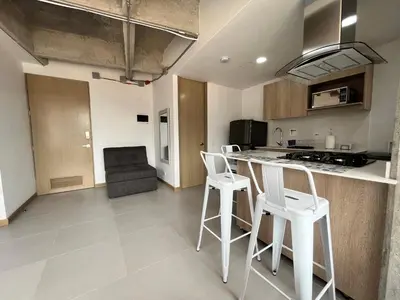 a kitchen with white stools and a counter top at Edificio Aiana Verde by Host Medellin in Medellín