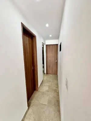 a hallway with a door and a tile floor at Laureles The NBHD apartments in Medellín