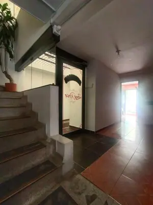 a lobby with stairs and a painting on the wall at Hotel ZONA ROSA MARINILLA in Marinilla
