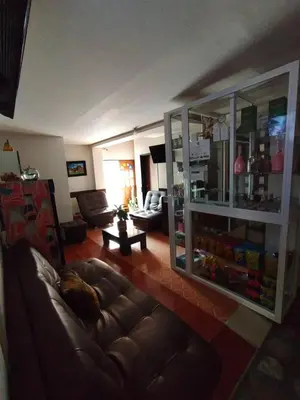 a living room with a brown leather couch in a room at Hotel ZONA ROSA MARINILLA in Marinilla