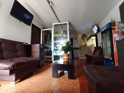 a living room with a couch and a table at Hotel ZONA ROSA MARINILLA in Marinilla