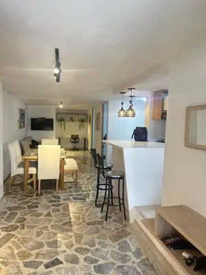 a kitchen and living room with a table and chairs at Modern House with Jacuzzi Stadium in Medellín