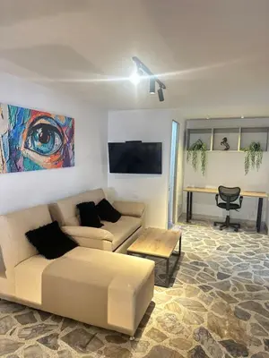 a living room with a couch and a table at Modern House with Jacuzzi Stadium in Medellín