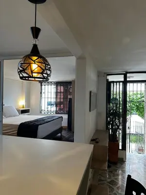 a bedroom with a bed and a table in a room at Modern House with Jacuzzi Stadium in Medellín