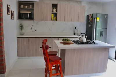 a kitchen with a island with a stove and a chair at Finca Hotel Recinto de la Gruta in Copacabana