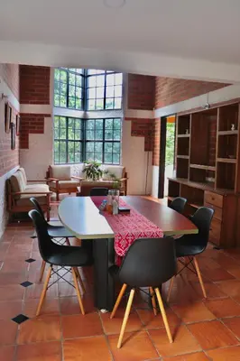 a dining room with a table and chairs in a room at Finca Hotel Recinto de la Gruta in Copacabana