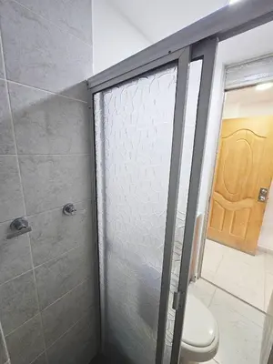 a bathroom with a glass shower with a toilet at Ágape 301 in Itagüí