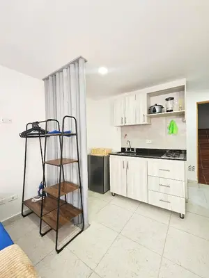 a kitchen with a ladder in the middle of a room at Ágape 301 in Itagüí