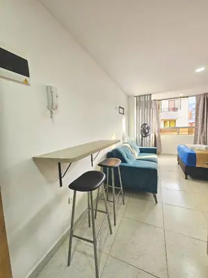 a living room with a couch and a table and stools at Ágape 301 in Itagüí