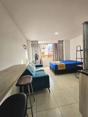 a room with two beds and a couch and a chair at Ágape 301 in Itagüí