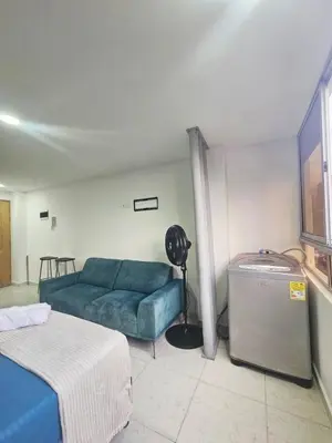 a living room with a blue couch and a bed at Ágape 301 in Itagüí