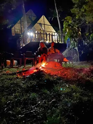 a fire in front of a house at night at Cabaña del rio, San Luis, Antioquia in San Luis