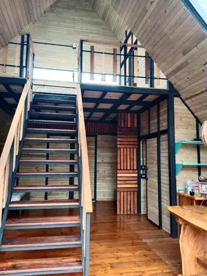 an empty room with stairs in a house at Cabaña del rio, San Luis, Antioquia in San Luis
