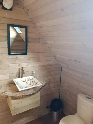 a bathroom with a sink and a toilet at Cabaña del rio, San Luis, Antioquia in San Luis