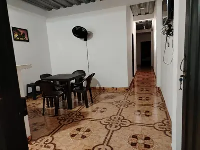 a dining room with a table and chairs on a tile floor at Apartamento por noches en Doradal in Las Mercedes