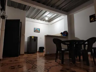a room with two chairs and a table and a refrigerator at Apartamento por noches en Doradal in Las Mercedes